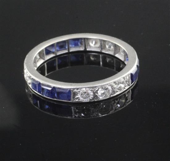 A 1940s/1950s platinum? sapphire and diamond set full eternity ring, size O.